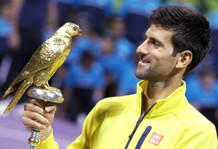 Novak Djokovic holds the trophy after winning the Qatar Open. REUTERS  Naseem Zeitoon