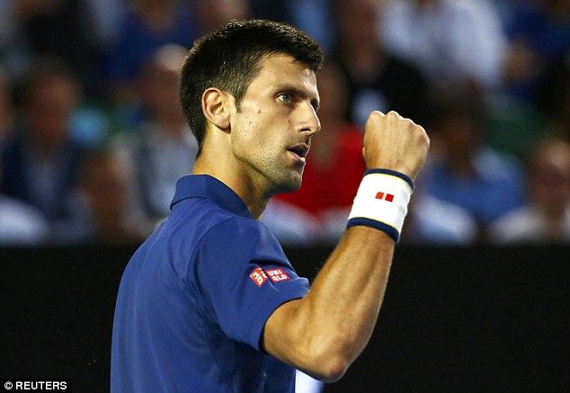 Novak Djokovic pumps his fist as he wins another point on his way to a four-set victory over Roger Federer