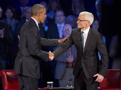 President Barack Obama left arrives for a CNN televised town hall meeting hosted by Anderson Cooper right at George Mason University in Fairfax Va. Thursday Jan. 7 2016. Obama's proposals to tighten gun controls rules may not accomplish his goal