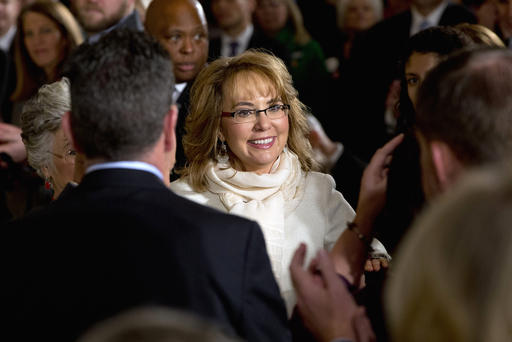 People applaud former Ariz. Rep. Gabby Giffords as she arrives in the East Room of the White House in Washington on Jan. 5 2016