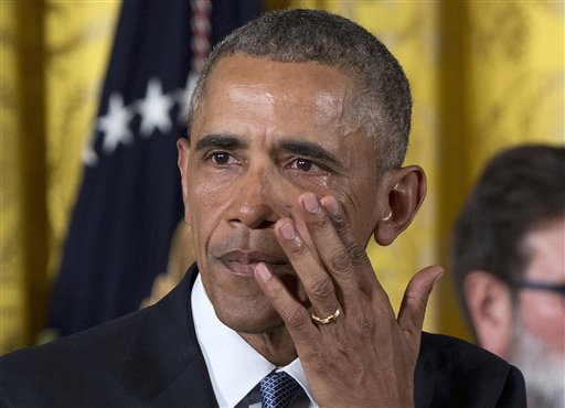 President Barack Obama wipes away tears from his eyes as he speaks in the East Room of the White House in Washington Tuesday Jan. 5 2016 about steps his administration is taking to reduce gun violence. Also on stage are stakeholders and individuals