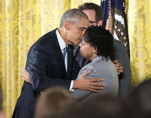 President Barack Obama embraces Jennifer Pinckney wife