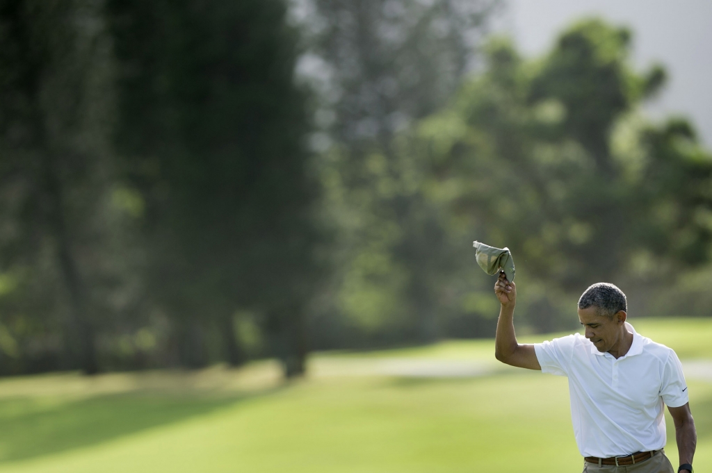 Obama tips his hat after finishing the 18th hole at the Mid Pacific Country Club golf course on Dec. 28 in Kailua