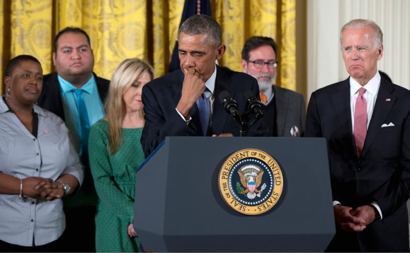 President Barack Obama joined by Vice President Joe Biden and gun violence victims pauses as he speaks in the East Room of the White House in Washington Tuesday Jan. 5 2016 about steps his administration is taking to reduce gun violence. (AP