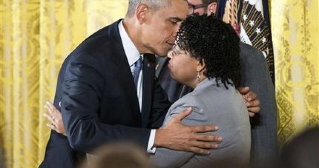 President Barack Obama embraces Jennifer Pinckney wife of Reverend Clementa Pinckney who was killed in the 2015 Charleston church shooting after speaking in the East Room of the White House in Washington Tuesday Jan. 5 2016 about steps his administ