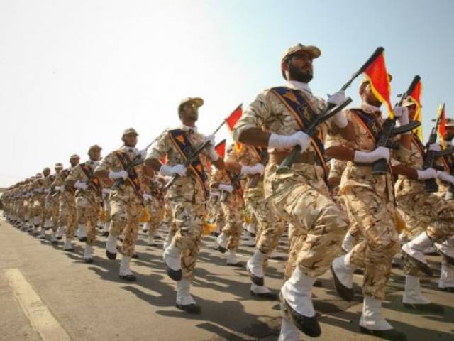 Members of the Iranian revolutionary guard march during a parade to commemorate the anniversary of the Iran Iraq war, in Tehran