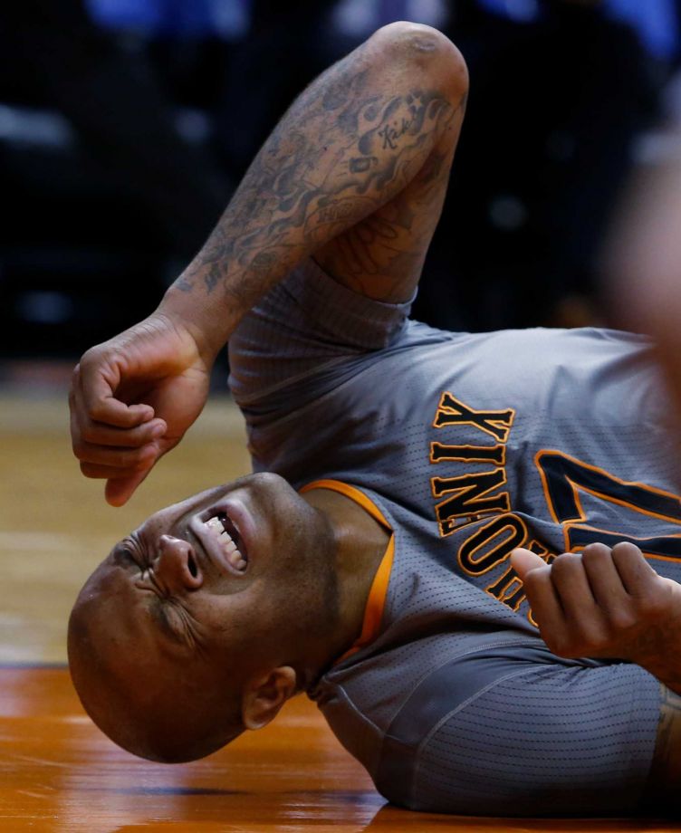 Phoenix Suns forward P.J. Tucker reacts after getting run into by San Antonio Spurs forward Kawhi Leonard in the first quarter during an NBA basketball game Thursday Jan. 21 2016 in Phoenix