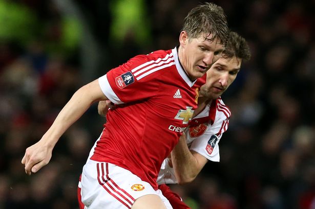 Manchester United's Bastian Schweinsteiger and Sheffield United's Chris Basham battle for the ball