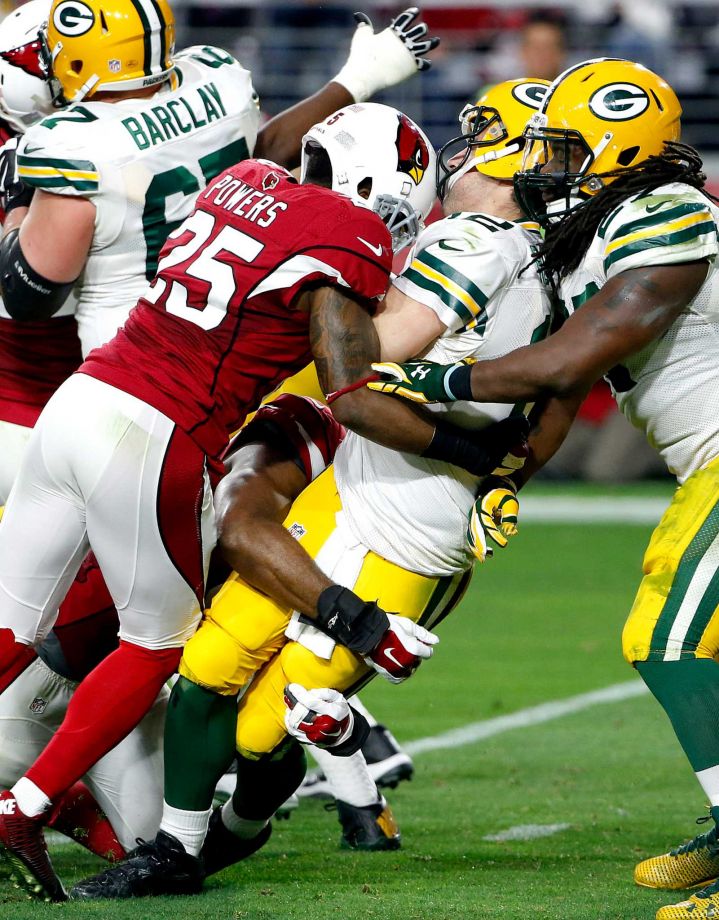 Green Bay Packers quarterback Aaron Rodgers is sacked by Arizona Cardinals cornerback Jerraud Powers during the second half of an NFL football game Sunday Dec. 27 2015 in Glendale Ariz