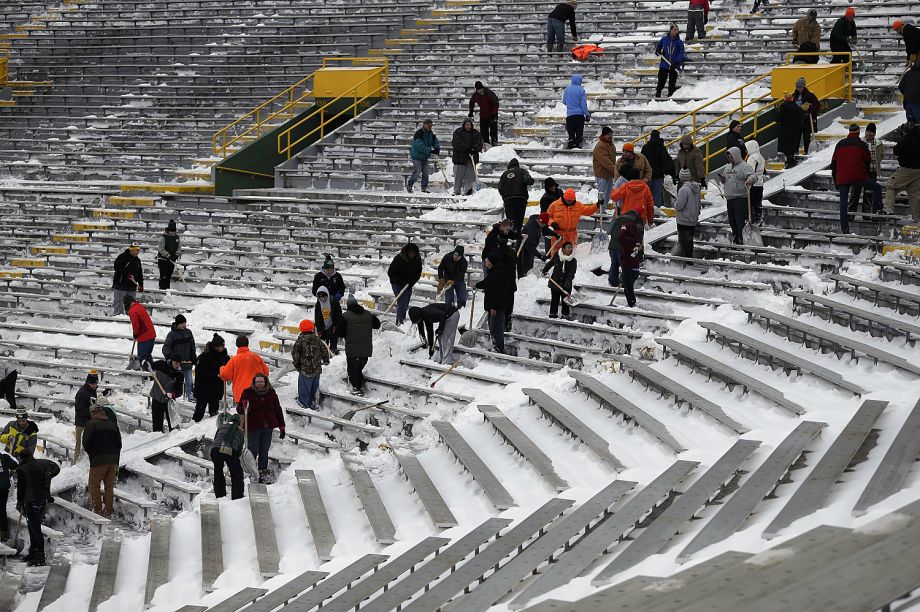 People help clear snow at Lambeau Field in Green Bay Wis. Thursday Dec. 31 2015. Hundreds of people helped clear snow and spread ice melt at Lambeau Field in preparation for an NFL football game between the Green Bay Packers and the Minnesota Vikings