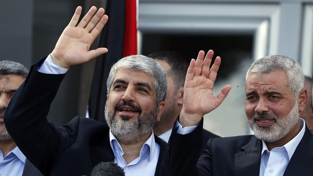 Exiled Hamas chief Khaled Mashaal left and Gaza's Hamas Prime Minister Ismail Haniyeh wave during a news conference upon Mashaal's arrival in the Gaza Strip on December 7