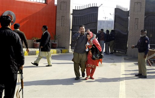 Staff of the Bacha Khan University leave the campus in Charsadda town some 35 kilometers outside the city of Peshawar Pakistan Wednesday Jan. 20 2016. Gunmen stormed Bacha Khan University named after the founder of an anti Taliban politica