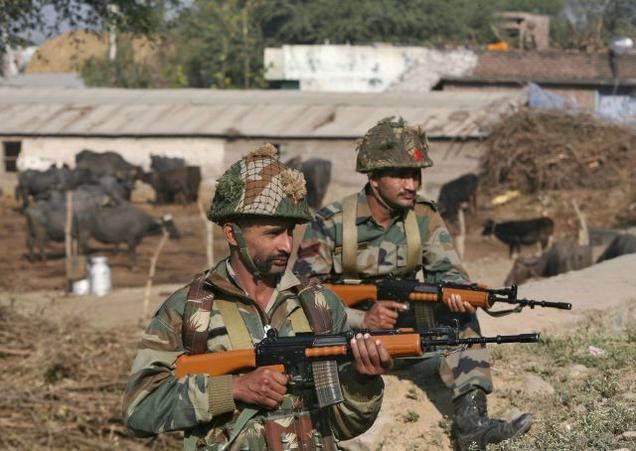 Army soldiers stand guard near the Indian Air Force base at Pathankot in Punjab