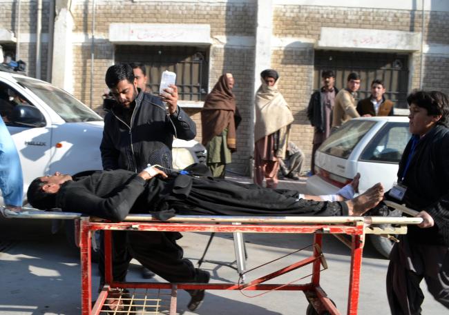 Pakistani paramedics move an injured survivor following a bomb blast near a polio vaccination centre at a hospital in Quetta on Wednesday