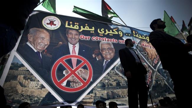 Palestinian protesters stand in front of a banner showing US Secretary of State John Kerry, former Israeli President Shimon Peres, and Palestinian President Mahmoud Abbas during a protest against the resumption of talks with Israel in the Jabalia