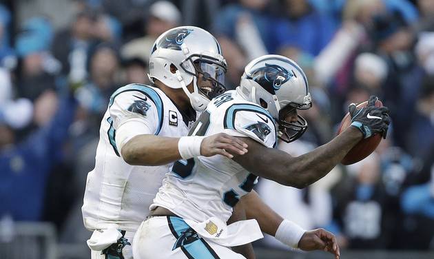 Carolina Panthers quarterback Cam Newton celebrates with Carolina Panthers outside linebacker Thomas Davis after Davis caught the onside kick made by Seattle Seahawks during the second half of an NFL divisional playoff football game Sunday Jan