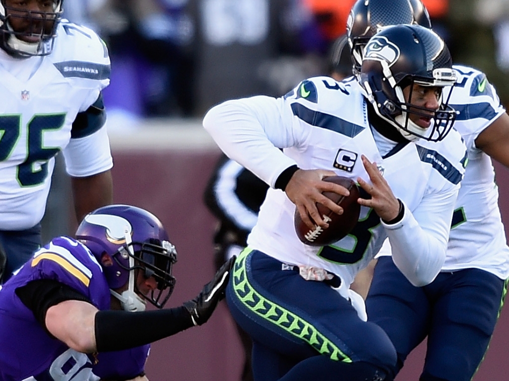 Quarterback Russell Wilson of the Seattle Seahawks runs in the second quarter against the Minnesota Vikings on Sunday during an NFC wild-card playoff game