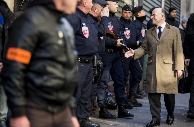 French Interior minister Bernard Cazeneuve meets with anti-riot CRS officers as he arrives to the Rue de la Goutte d'Or in northern Paris