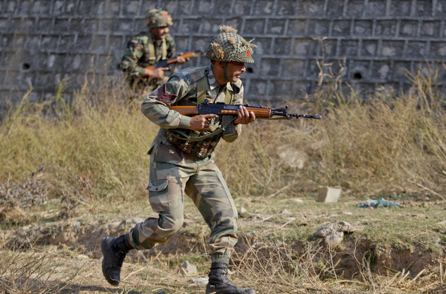 Indian army soldiers conduct a search operation in a forest area outside the Pathankot air force base in Pathankot India Sunday Jan. 3 2016. Combing oper