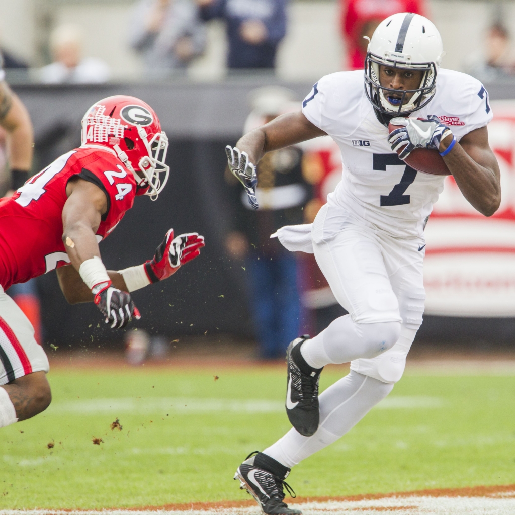 TaxSlayer Bowl Football Penn State wide receiver Geno Lewis runs after a reception as Georgia's Dominick Sanders closes in during the first half of the Tax Slayer Bowl on Jan. 2