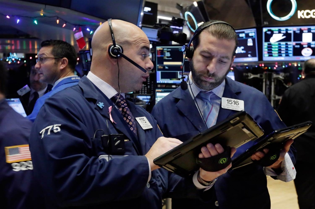 Image People consult on the floor of the New York Stock Exchange