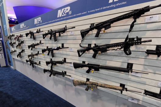 An attendee looks at Smith & Wesson M&P15 MOE Mid rifles at the Smith & Wesson booth at a gun show