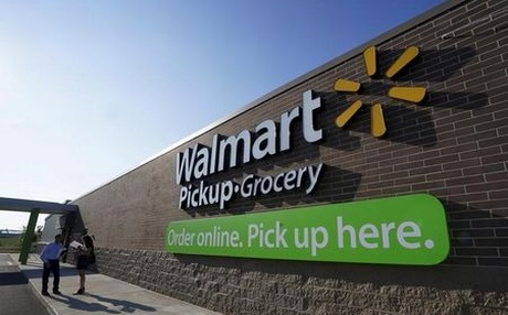 People talk outside a Wal Mart Pickup-Grocery test store in Bentonville Arkansas