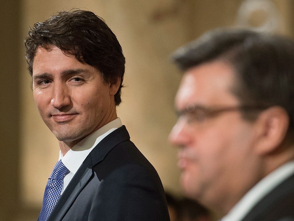 Prime Minister Justin Trudeau left looks on as Montreal Mayor Denis Coderre speaks during a news conference in Montreal Tuesday