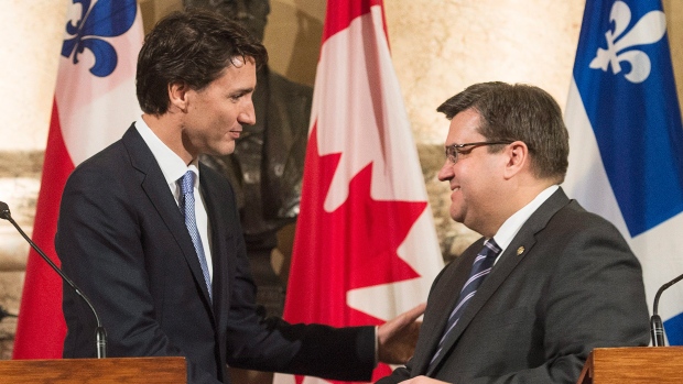 Prime Minister Justin Trudeau left shakes hands with Montreal Mayor Denis Coderre following their joint press conference in Montreal Tuesday