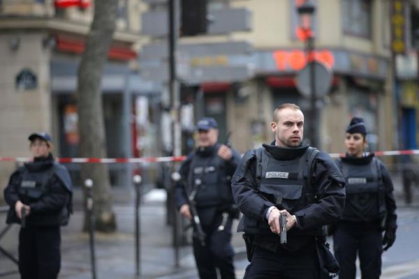 Police officers secure the perimeter near the scene