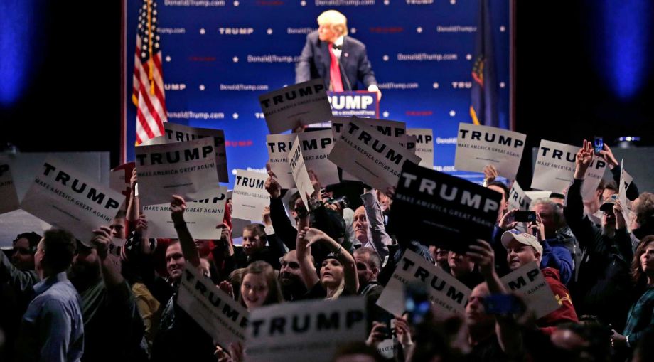 Supporters turn to show their support as a protestor interrupts an address by Republican presidential candidate Donald Trump during a campaign stop at the Flynn Center of the Performing Arts in Burlington Vt. Thursday Jan. 7 2016