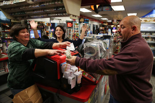 Gale Call and Sherrie Haines sell a Powerball ticket to Mike Nastasi at a BP gas station Jan. 6 2015 in Dunkirk Md