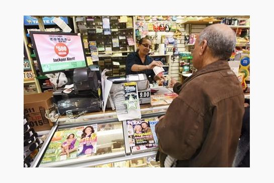 Vilas Patel sells a Powerball ticket to Pravin Bhatt right at Leprechaun News in Rutherford N.J. Wednesday Jan. 6 2016. The estimated Powerball jackpot for Wednesday night has soared to $500 million. The last time Powerball had grown this large was