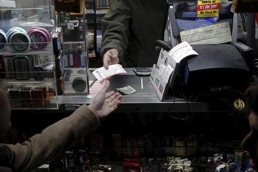 A customer purchases a Powerball lottery tickets at a news stand on Jan. 13 2016