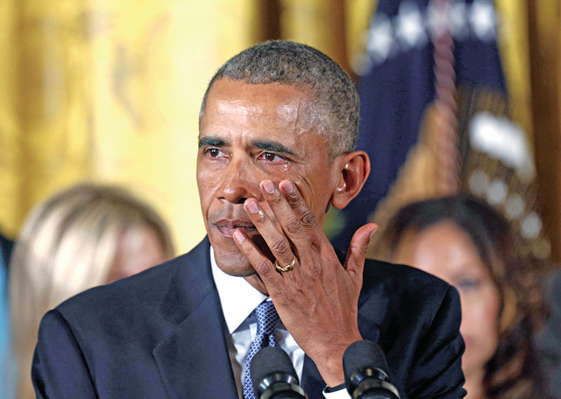 US President Obama wipes away tears during an event held to announce new gun control measures at the White House in Washington