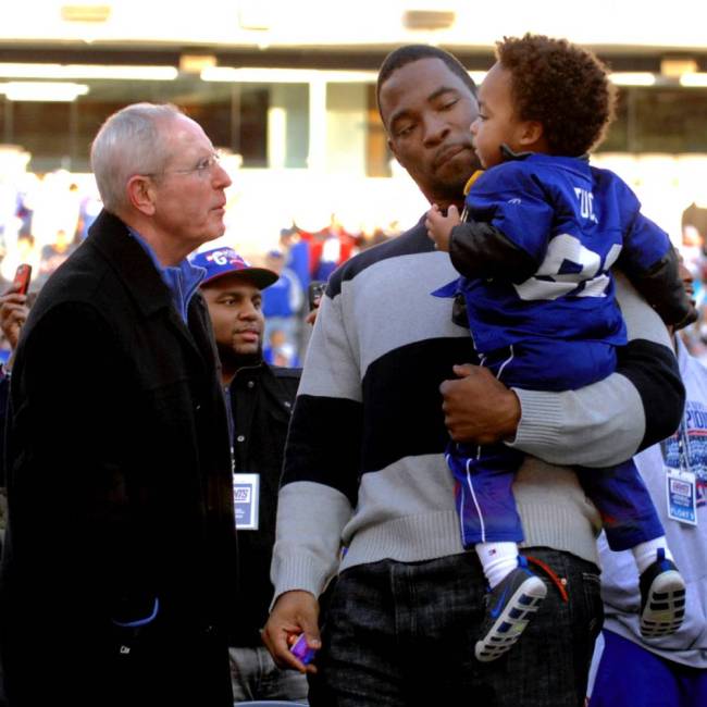 Two-time Super Bowl champs Tom Coughlin and Justin Tuck with Tuck’s son Jayce in 2012