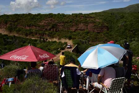 People watch the cars passing during the 2016 Dakar Rally’s Stage 2 between Villa Carlos Paz and Termas de Rio Hondo Argentina on Tuesday. Peugeot’s French driver Sebastien Loeb won the stage ahead of Peugeot’s Stephane Peterhansel and Toyota’s