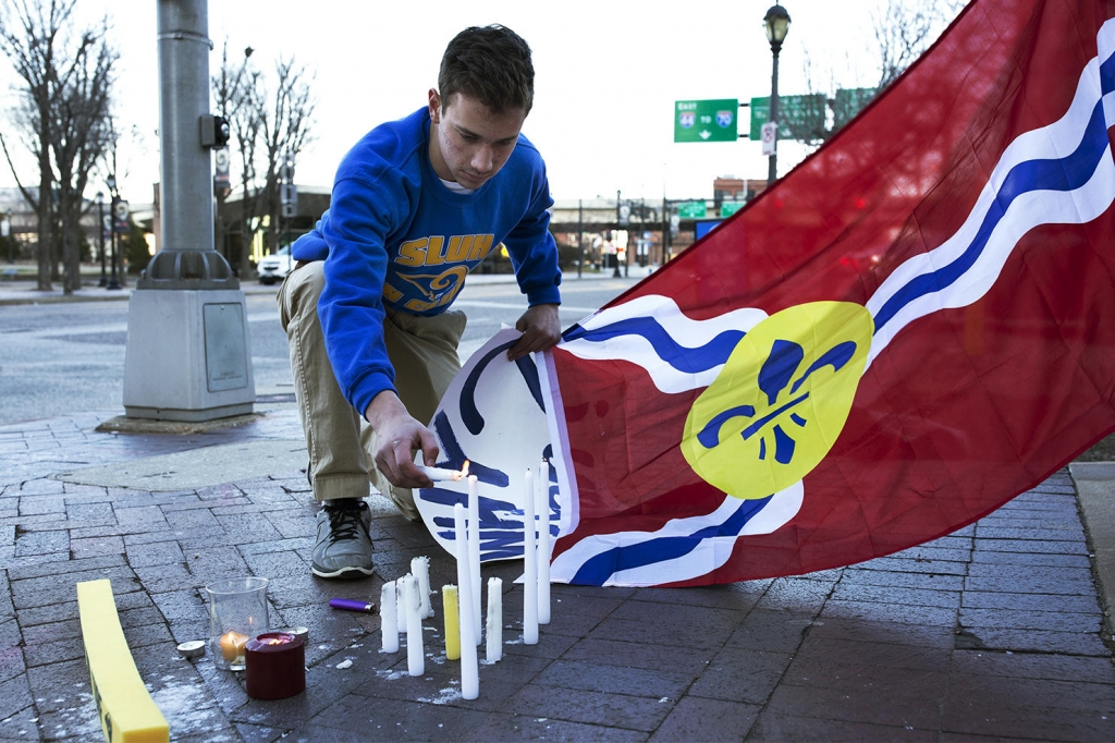 Sam Sextro lights candles across the street from the Edward Jones Dome while mourning the city's loss of the Rams. Sextro and a friend who ran a St. Louis University High Rams fan club met outside the stadium Wednesday for a'final tailgate