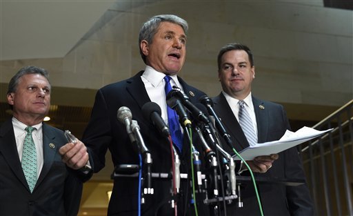 House Homeland Security Committee Chairman Rep. Michael McCaul R-Texas center flanked by Rep. Buddy Carter R-Ga. left and Rep. Richard Hudson R-N.C. speaks to reporters on Capitol Hill in Washington Friday Jan. 8 2016 about the arrest of two Ir