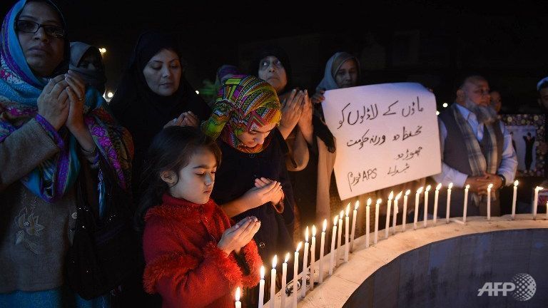 Relatives of the 2014 Peshawar school attack victims light candles for the victims of the Bacha Khan university