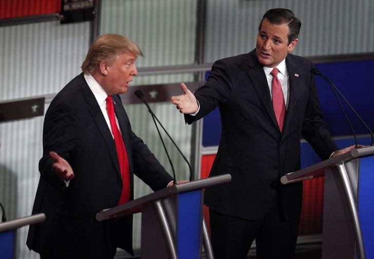 Republican presidential candidate businessman Donald Trump and Senator Ted Cruz speak simultaneously at the Fox Business Network Republican presidential candidates debate in North Charleston South Carolina