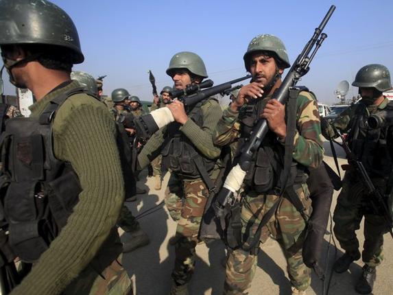 Army soldiers walk outside the Bacha Khan university in Charsadda Pakistan