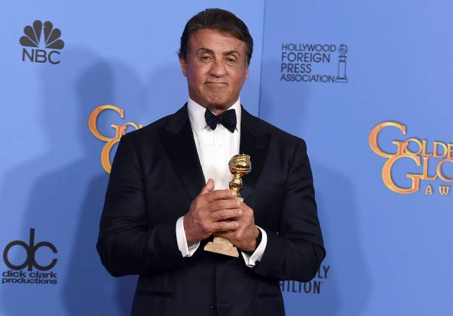 Sylvester Stallone poses in the press room with the award for best performance by an actor in a supporting role in a motion