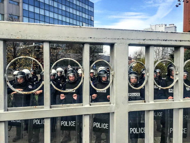 Riot police barricade the parliament's entrance ahead of an opposition protest in Pristina