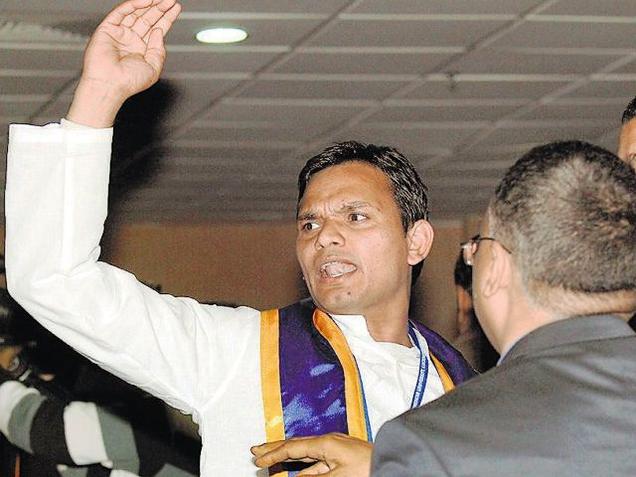 A student staging a protest during Prime Minister Narendra Modi's speech at the convocation of Babasaheb Bhimrao Ambedkar University in Lucknow on Friday