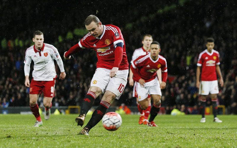 Manchester United's Wayne Rooney scores their first goal with a penalty during their FA Cup third round football match against Sheffield United at Old Trafford. – Reuters pic