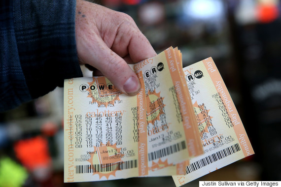 SAN LORENZO CA- JANUARY 13 A customer holds a handful of Powerball tickets at Kavanagh Liquors