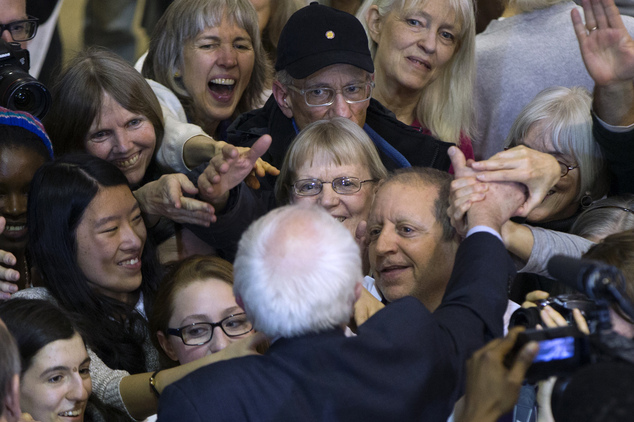 People reach out to shake hands with Democratic presidential candidate Sen. Bernie Sanders I-Vt. during a campaign rally at the Sondheim Center on Thursday