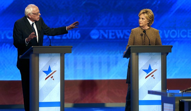 Bernie Sanders left offers an apology to Hillary Clinton during a Democratic presidential primary debate Saturday Dec. 19 2015 at Saint Anselm College in Manchester N.H