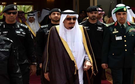 Saudi Arabia’s King Salman with military officials